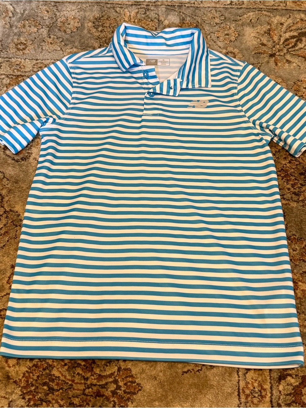 Boy’s New Balance polo shirt with blue and white stripex